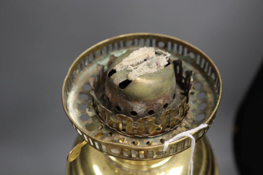 A brass oil lamp, with horn stem, 23in.